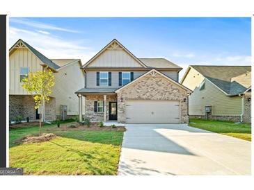 Inviting two-story home with a well-manicured lawn and a spacious two-car garage at 2376 Aukerman Trce, Hampton, GA 30228