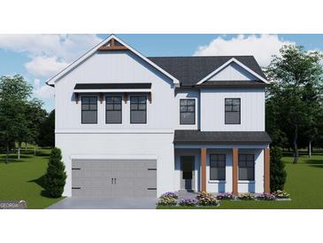 Charming two-story home featuring a modern farmhouse design, white siding and brick, and a gray garage door at 704 Bristol Dr # 153A, Loganville, GA 30052