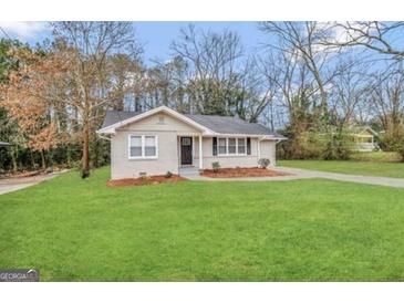 Charming single-story home with a well-maintained lawn and paved driveway at 1643 Columbia Dr, Decatur, GA 30032