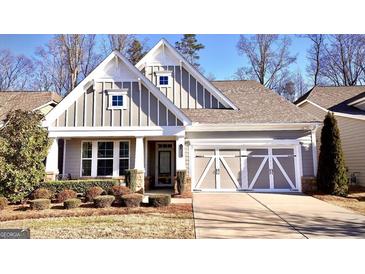 Charming home with a two-car garage, well-manicured lawn and attractive contrasting white and gray trim at 2455 Westlington Cir, Cumming, GA 30040