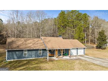 Charming home with a welcoming front porch, mature trees, and a two-car garage at 105. Meadow Springs Ct, Locust Grove, GA 30248