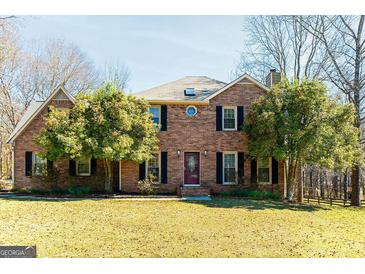 Two-story brick home featuring a lush front lawn and mature trees at 260 Brookwood Ln, Fayetteville, GA 30215