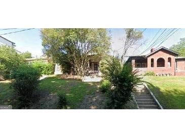 Charming brick home with mature trees and a well-maintained lawn at 586 Glen Iris Ne Dr, Atlanta, GA 30308