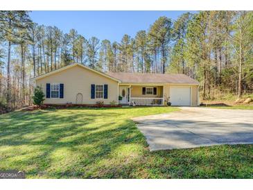 Charming single-story home with a well-manicured lawn and inviting front porch, offering a cozy and welcoming curb appeal at 178 Norman Rd, Covington, GA 30014