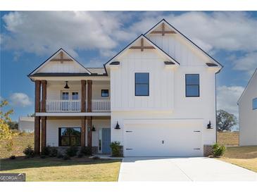 Inviting two-story home featuring a white exterior, a balcony, and a spacious two-car garage at 4130 Chapel Hill Reserve, Douglasville, GA 30135