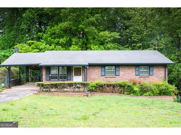 Charming brick ranch home with a well-maintained front yard and covered carport at 2102 Mulkey Sw Rd, Marietta, GA 30008