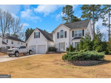Charming two-story home with a well-maintained front yard and attached two-car garage at 1191 Berryhill Dr, Lithonia, GA 30058