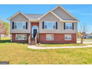 Charming two-story home with brick accents and manicured lawn, perfect curb appeal at 1515 Summer Lake Ter, Loganville, GA 30052