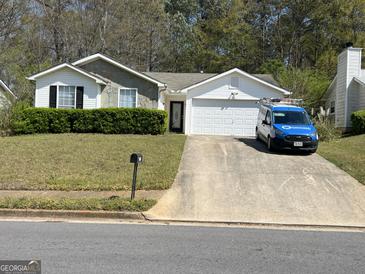 Charming one-story home with a two-car garage, well-manicured lawn, and a concrete driveway at 122 Lake Ter, Mcdonough, GA 30253