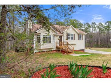 Charming single-story home featuring a welcoming front porch and well-maintained landscaping at 370 Burton Dr, Douglasville, GA 30134