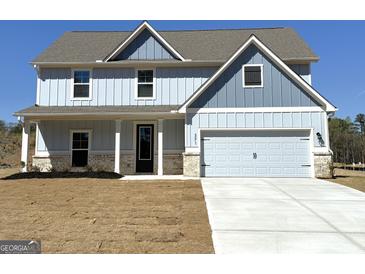 Charming two-story home with light blue siding, a two-car garage, and a well-manicured lawn at 371 Cantrell Drive, Dallas, GA 30157