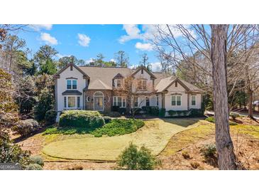 Charming two-story home with landscaped yard, circular driveway, and beautiful stone and stucco exterior at 610 Graystone Ct, Peachtree City, GA 30269