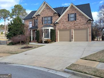 Charming two-story brick home featuring a two-car garage, well-manicured lawn, and traditional architectural details at 107 Heatherwood Trce, Acworth, GA 30101
