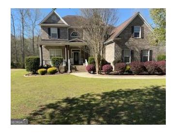 Spacious backyard with a patio, fire pit, and ample space for outdoor activities at 711 Lily Glen Ln, Stockbridge, GA 30281