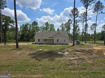 New construction home featuring light siding and a covered front porch on a spacious lot at 22638 Salem Church Rd, Metter, GA 30349