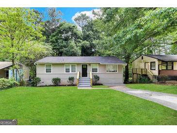 Charming single-story home featuring a lush green lawn and a freshly painted exterior at 3122 Latona Sw Dr, Atlanta, GA 30354