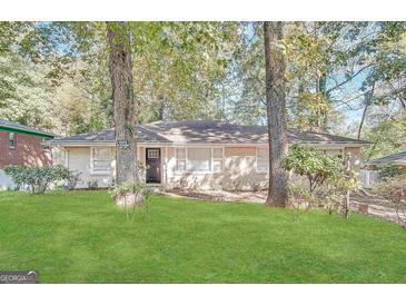 Charming single-story home with a well-maintained front yard and mature trees, offering great curb appeal at 1923 Rosewood Rd, Decatur, GA 30032