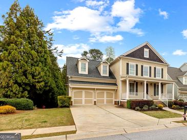 Charming two-story home featuring a two-car garage and a welcoming front porch, perfect for suburban living at 1301 Blue Sky Ct, Peachtree City, GA 30269