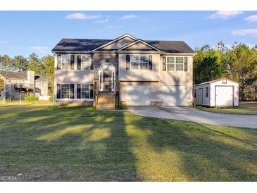 Charming two-story home featuring a well-manicured front yard, two-car garage, and inviting curb appeal at 217 Old Carrollton Rd, Carrollton, GA 30116