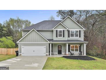 Charming two-story home with a well-maintained lawn and attached two-car garage at 205 Valley View Dr, Tyrone, GA 30290