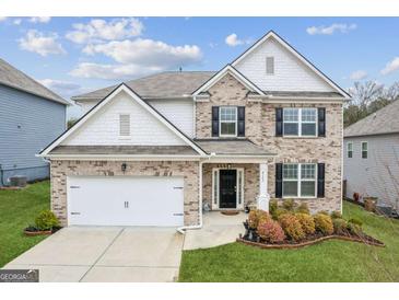 Charming two-story home with well-maintained lawn and landscaping features a two car garage at 4365 Sunflower Cir, Cumming, GA 30040