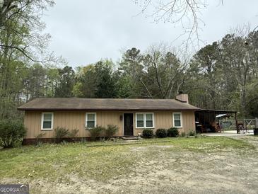 Charming single-story home featuring a covered patio and a classic brown exterior at 4389 & 4381 Campbell Rd, Snellville, GA 30039