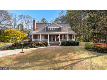 Beautiful front exterior with a welcoming porch and well-manicured lawn at 135 Horseshoe Cir, Fayetteville, GA 30215