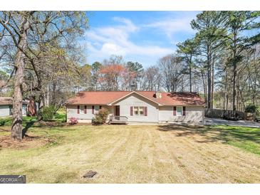 Charming single-story home with a well-maintained lawn and mature trees in a peaceful setting at 104 Amberidge Nw Dr, Cartersville, GA 30121