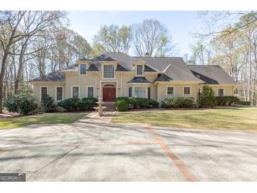 Stately home featuring mature landscaping, fountain, circular driveway, and impeccable curb appeal at 115 Flagstop Run, Fayetteville, GA 30215