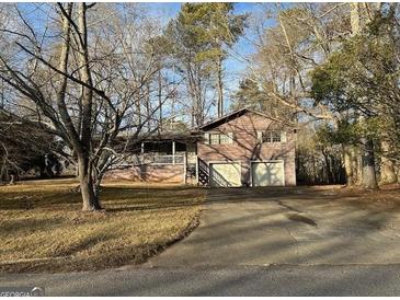 Split level home featuring an attached two car garage and covered front porch at 191 Charles Cox Dr, Canton, GA 30115