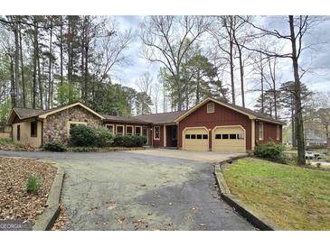 Charming home with stone accents, two-car garage, and a large driveway at 2996 Jodeco Dr, Jonesboro, GA 30236