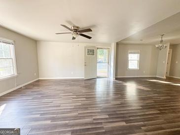 Bright living room with wood flooring, ceiling fan and natural light at 710 Bluebird Se Dr, Conyers, GA 30094