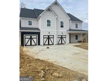 Charming two-story home boasts a three-car garage with modern black and white doors at 138 Silvercrest Dr # 169, Acworth, GA 30101