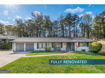 Charming renovated single-story home boasts a manicured lawn and inviting curb appeal at 3685 Concordia Rd, Decatur, GA 30034