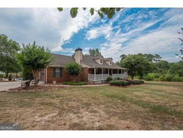Charming single-Gathering home with a brick exterior, complemented by a well-maintained lawn and mature trees at 245 Jewel Blf, Fayetteville, GA 30214