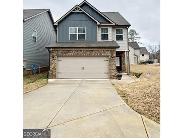 Charming two-story home with a two-car garage and neutral color scheme at 2275 Church St, Hampton, GA 30228