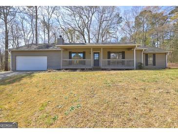 Charming single-story home with a covered porch and attached garage, set on a grassy lot at 130 Bradley Pl, Mcdonough, GA 30253