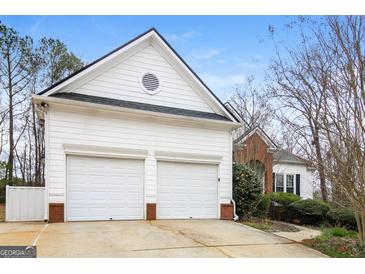 Two-car garage with white doors and matching trim offers ample parking and storage at 364 Valleyside Dr, Dallas, GA 30157