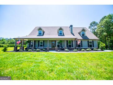 Charming single-story home featuring a welcoming front porch, dormer windows, and a well-manicured front yard at 640 Lovell Rd, Temple, GA 30179