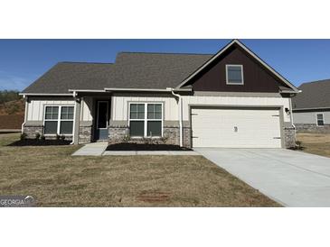 Charming single-Gathering home featuring a two-car garage, brick accents, and neutral paint scheme at 587 Cantrell Drive, Dallas, GA 30157