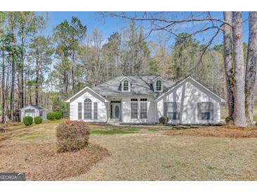 Charming one-story white home with dormer windows and a well-manicured front yard at 147 Kripple Kreek Dr, Sharpsburg, GA 30277