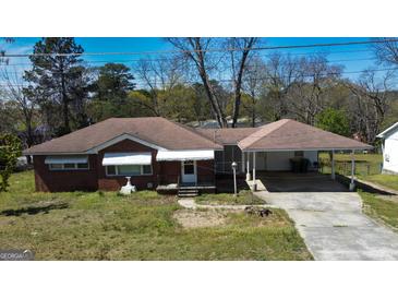 Charming brick home with carport and landscaped yard, perfect for outdoor living at 4487 Berkshire Rd, Forest Park, GA 30297