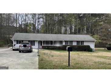 Charming single story home featuring a welcoming front porch and driveway at 2387 Shire Ct, Austell, GA 30106