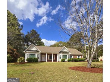 Charming single-story home featuring a well-manicured lawn and traditional architectural details at 248 Valley Way, Hampton, GA 30228