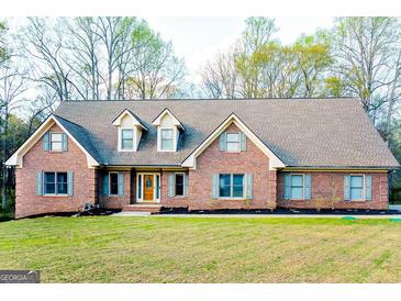 Charming brick home with well-manicured lawn and inviting curb appeal at 801 Streamside Dr, Mcdonough, GA 30252