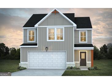 Inviting two-story home featuring a two-car garage and charming exterior lighting at 328 Wandering Brook Dr # 39, Mcdonough, GA 30253