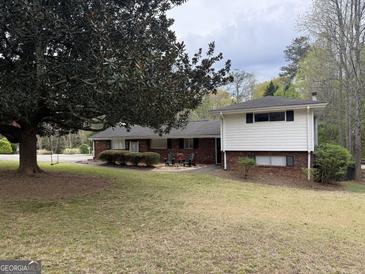 Charming brick home with manicured landscaping and a cozy outdoor seating area at 362 Mayfield Cir, Alpharetta, GA 30009