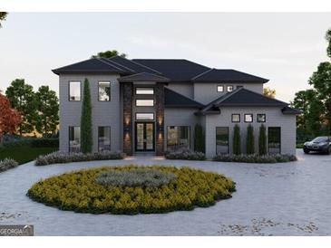 Stunning two-story home with gray brick exterior and circular landscaped driveway at 2704 Antioch Ne St, Conyers, GA 30013