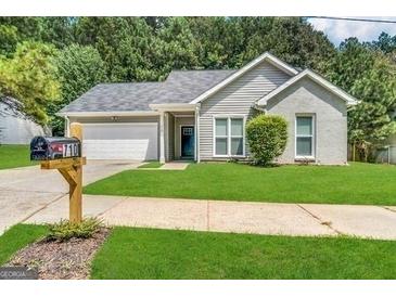 Charming single-story home with manicured lawn and a well-maintained exterior and a convenient attached garage at 710 Thomasville Se Blvd, Atlanta, GA 30315