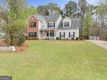 Charming two-story home with a brick facade and manicured lawn at 240 Sturgess Run, Sharpsburg, GA 30277